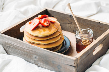 breakfast in the bad with pancakes and strawberry