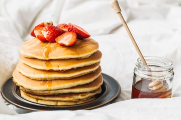 breakfast in the bad with pancakes and strawberry