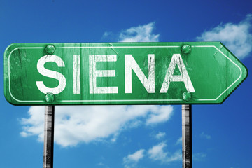 Siena road sign, vintage green with clouds background