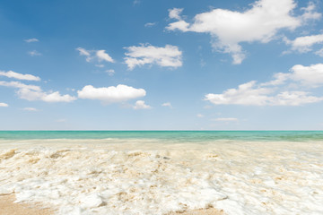 Fototapeta na wymiar Beautiful beach and tropical sea, Wave of the sea on the sand beach and blue sky background...