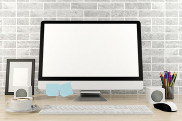 Fototapeta premium Isolated computer display for mockup in office interior. Working desk with keyboard, mouse, speaker, cup of coffee, pencils, frame