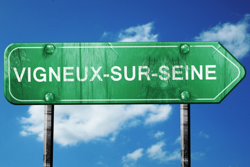 vigneux-sur-seine road sign, vintage green with clouds backgroun