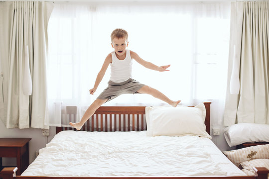 Boy Jumping On The Bed