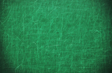 Green scratched blackboard dark around the edges