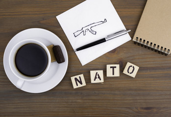 Text: Nato from wooden letters on awooden table