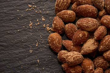 nuts, salted almonds, on a dark background