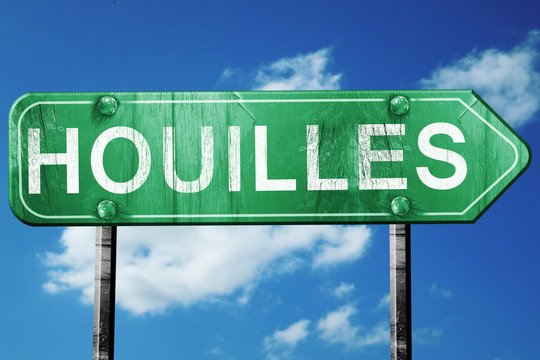 houilles road sign, vintage green with clouds background