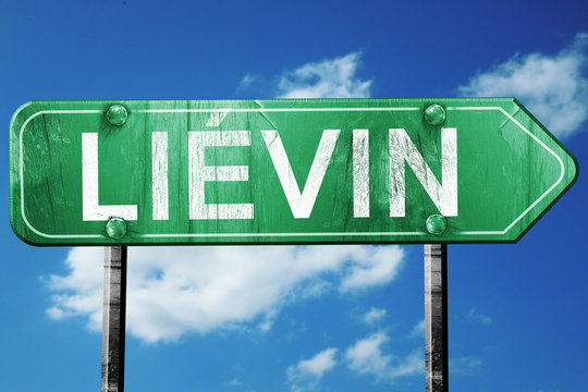 lievin road sign, vintage green with clouds background