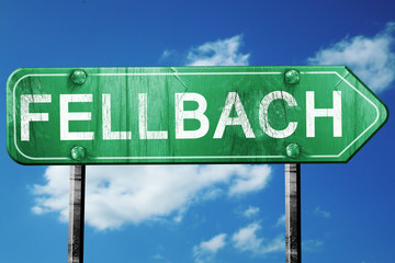 Fellbach road sign, vintage green with clouds background