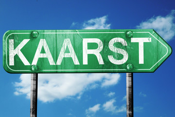 Kaarst road sign, vintage green with clouds background