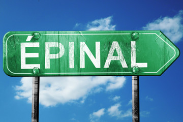 Epinal road sign, vintage green with clouds background
