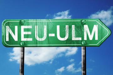 Neu-ulm road sign, vintage green with clouds background