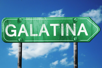 Galatina road sign, vintage green with clouds background