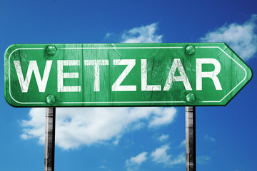 Wetzlar road sign, vintage green with clouds background