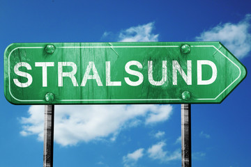 Stralsund road sign, vintage green with clouds background