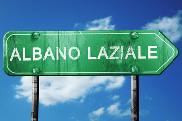 Albano laziale road sign, vintage green with clouds background