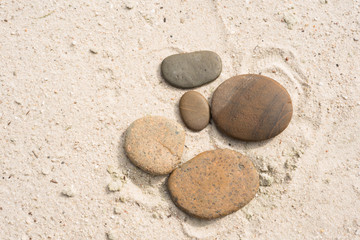 Fototapeta na wymiar five zen stones with copy space lying on the beach