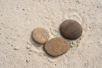 Fototapeta na wymiar three zen stones with copy space lying on the beach