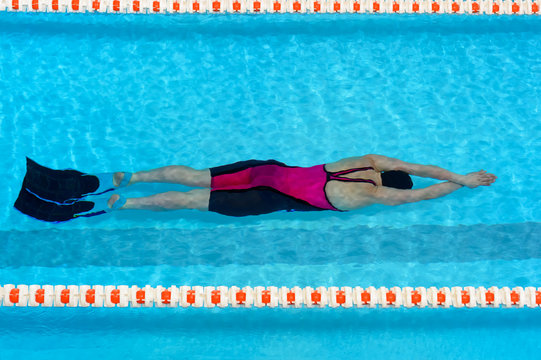 Woman swimming in a pool.