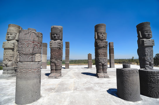 Atlantean figures and ancient pillars against blue sky
