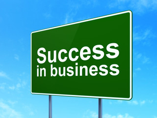 Finance concept: Success In business on road sign background