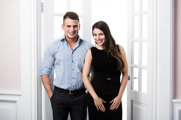 Fototapeta premium Couple of young stylish business people in the doorway home interior loft office