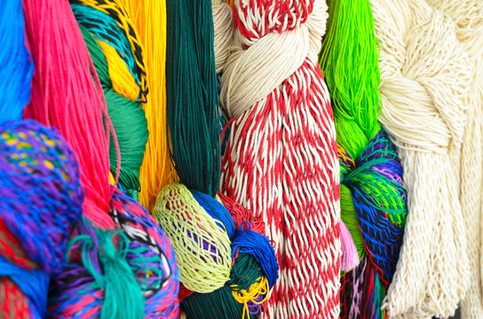 Closeup of colorful hammocks hanging knotted at the craft market 