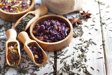 Assorted dried tea leaves on wooden background