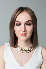 Portrait of young beautiful woman with middle length hair and smoky eyes make-up