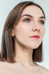 Fototapeta premium Beauty portrait of young model with middle length hair. Professional nude makeup. Green eyes.