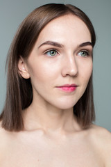 Obraz premium Beauty portrait of young model with middle length hair. Professional nude makeup. Green eyes.