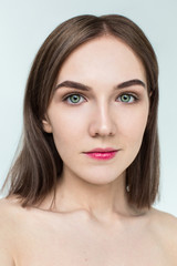 Beauty portrait of young model with middle length hair. Professional nude makeup. Green eyes.