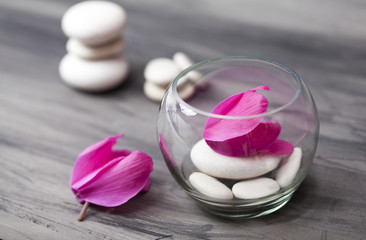 Spa still life with pink orchid, white zen stone and tea candle