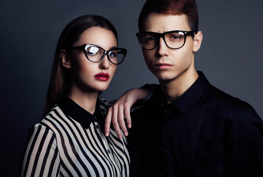 Fashion models couple wearing sunglasses. Sexy woman and handsom