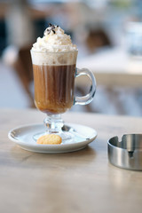 Latte with whipped cream outdoors