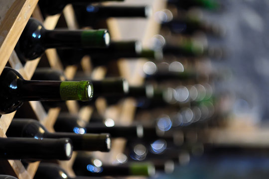 Fototapeta Wine bottles stacked on wooden racks