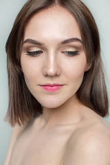 Fototapeta premium Beauty portrait of a pretty girl with makeup matte shadows on the eyes and pink lips