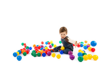 Fototapeta na wymiar baby plays with color balls