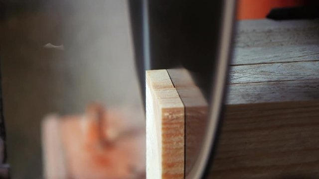 Close view. Most saw aligns edges of the boards, cutting them.