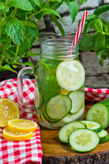 Water with lemon, mint and cucumber on wooden background. Water Detox.