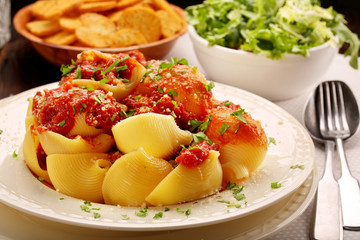 Lumaconi pasta with tomato sauce, bruschetta and salad