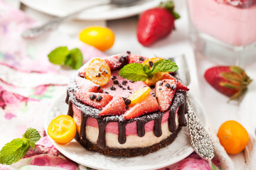 Delicious mini cheesecake decorated with berries and chocolate