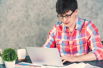 Male using laptop concrete