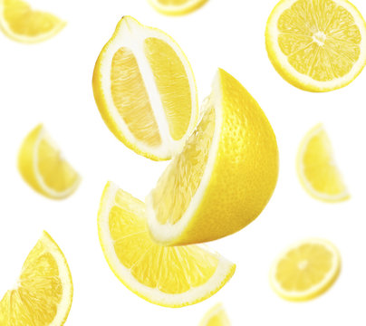 Falling ripe lemons isolated on white