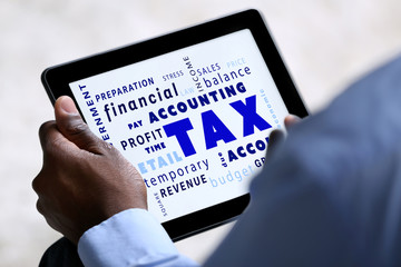 Tax concept. Male hands with tablet, close up