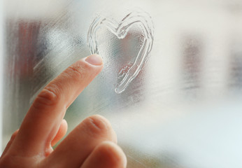 Heart drawn on the fogged glass window