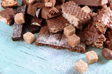 Chocolate sweets with powder on wooden background