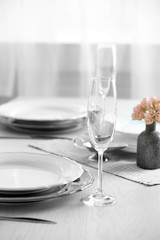 Table set at restaurant on light background