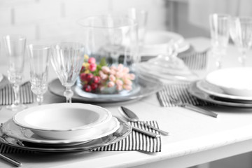 Table set at restaurant on light background