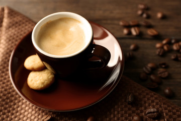 Cup of coffee on wooden table background